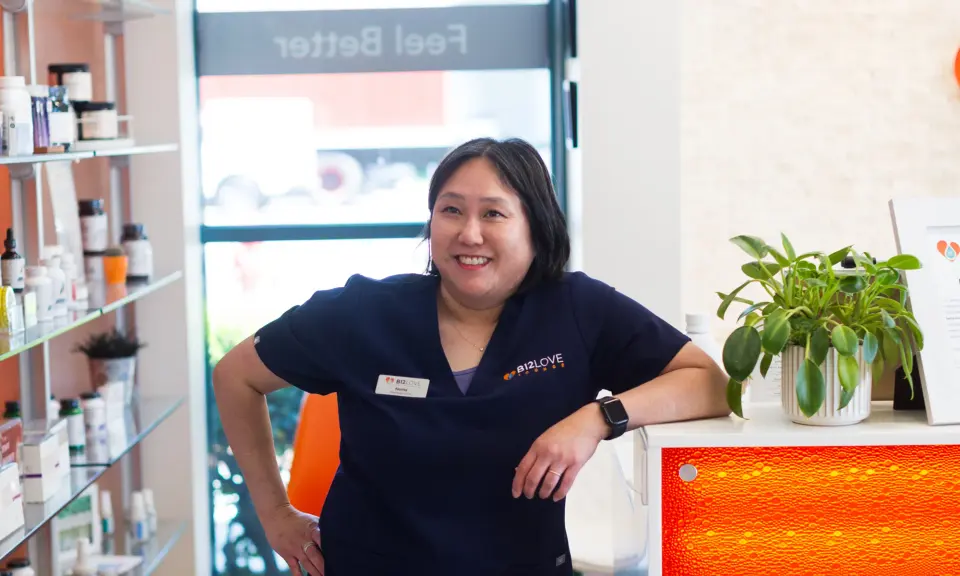 Staff member at the front counter and retail shelves at B12 LOVE Campbell