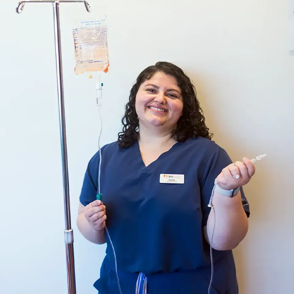 Emma, a B12 LOVE Campbell team member, beside an IV pole