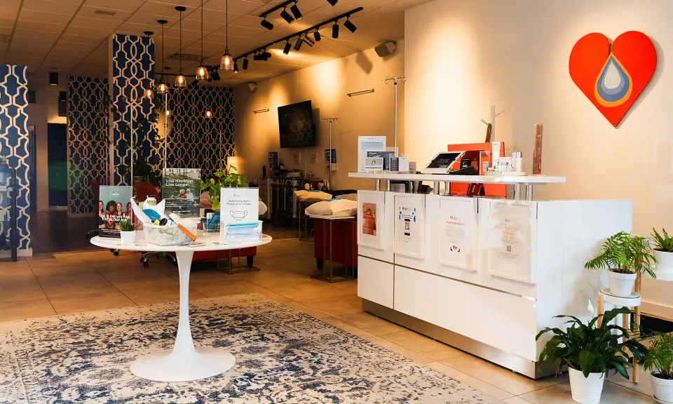 Front desk, retail table and patterned rug inside B12 LOVE Cow Hollow