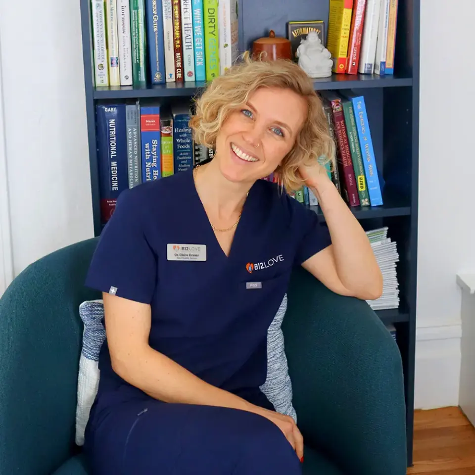 Dr. Claire of the B12 LOVE San Francisco team seated by a bookshelf