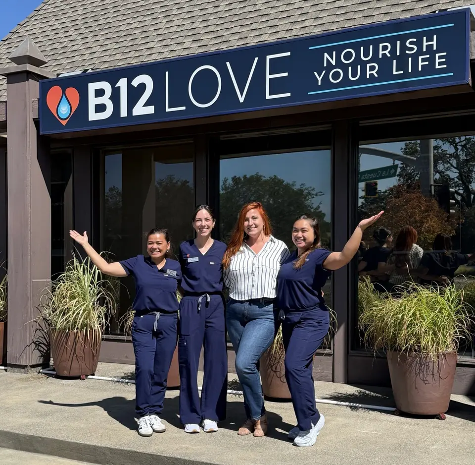 B12 LOVE Greenbrae staff in front of the storefront sign