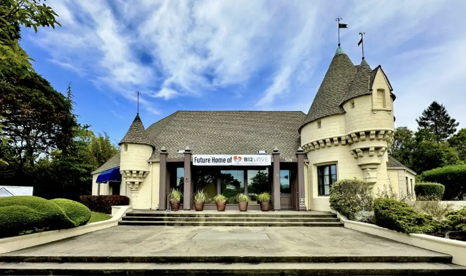 Castle-style building with a 'Future Home of B12 LOVE' sign in Greenbrae