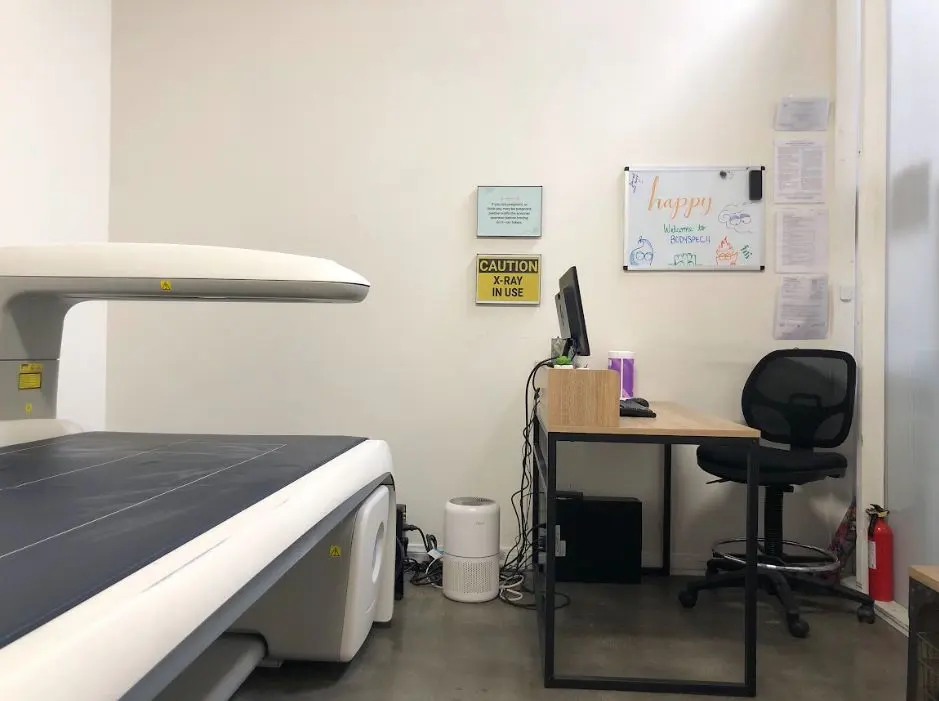 DEXA scanner and technician desk in the scan room at BodySpec Culver City