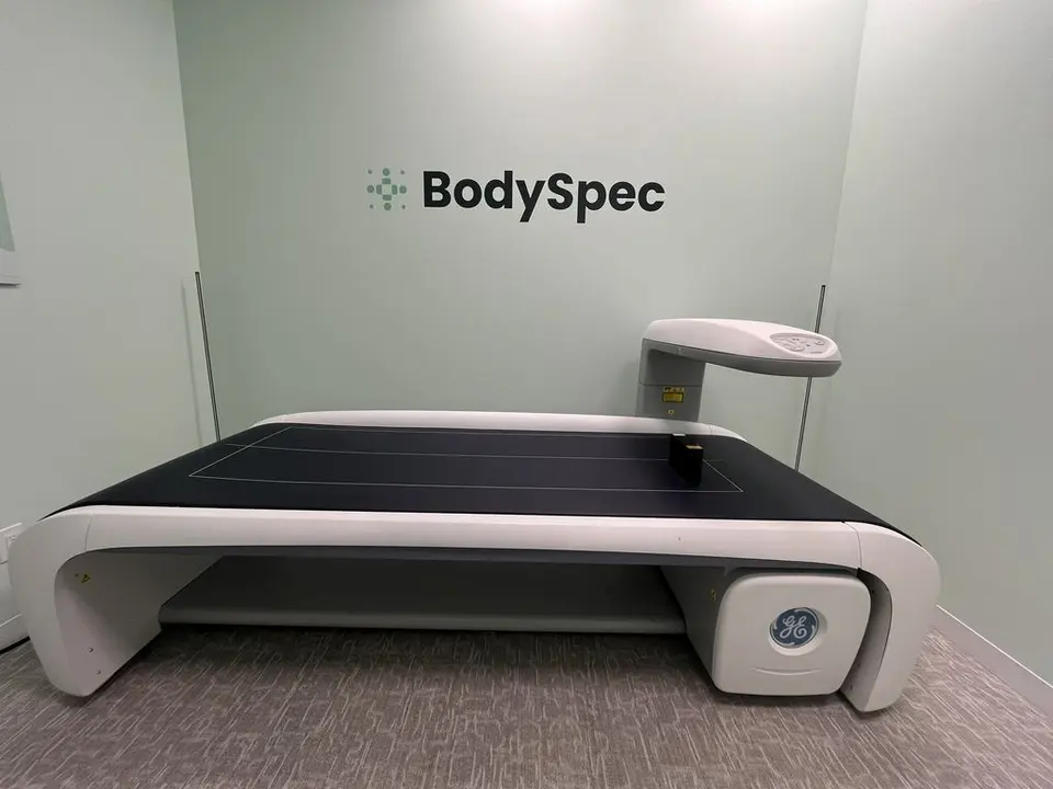 DEXA scanner under BodySpec wall logo at BodySpec SF Marina