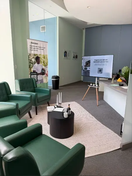 Lounge with green armchairs at BodySpec SF Rincon Hill