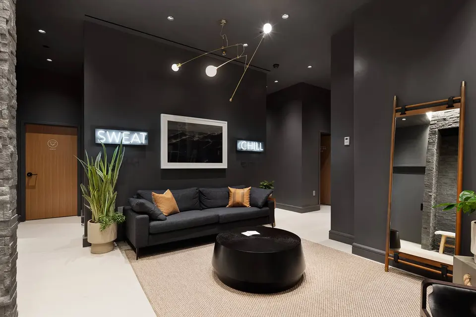 Dark lounge with sofa outside the Sweat and Chill rooms at Clean Market FiDi