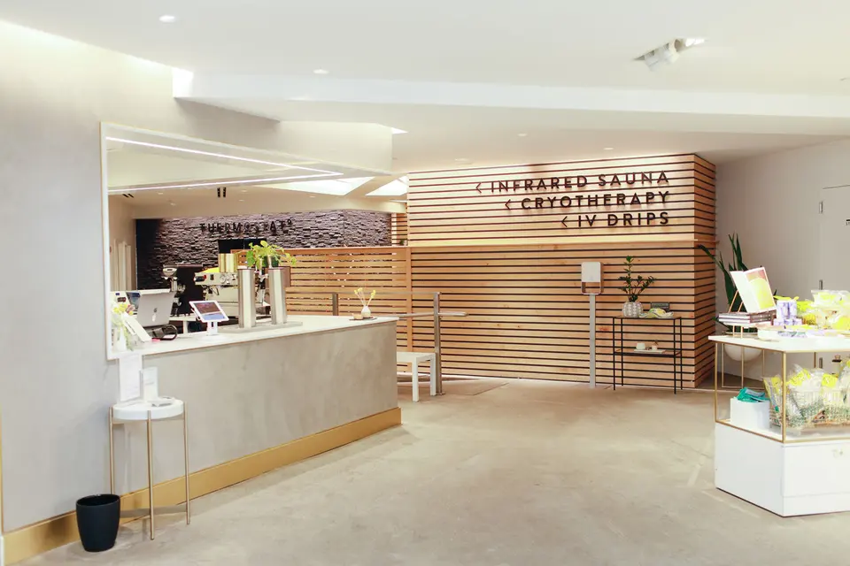 Front desk with signage for infrared sauna, cryotherapy and IV drips at Clean Market Midtown East