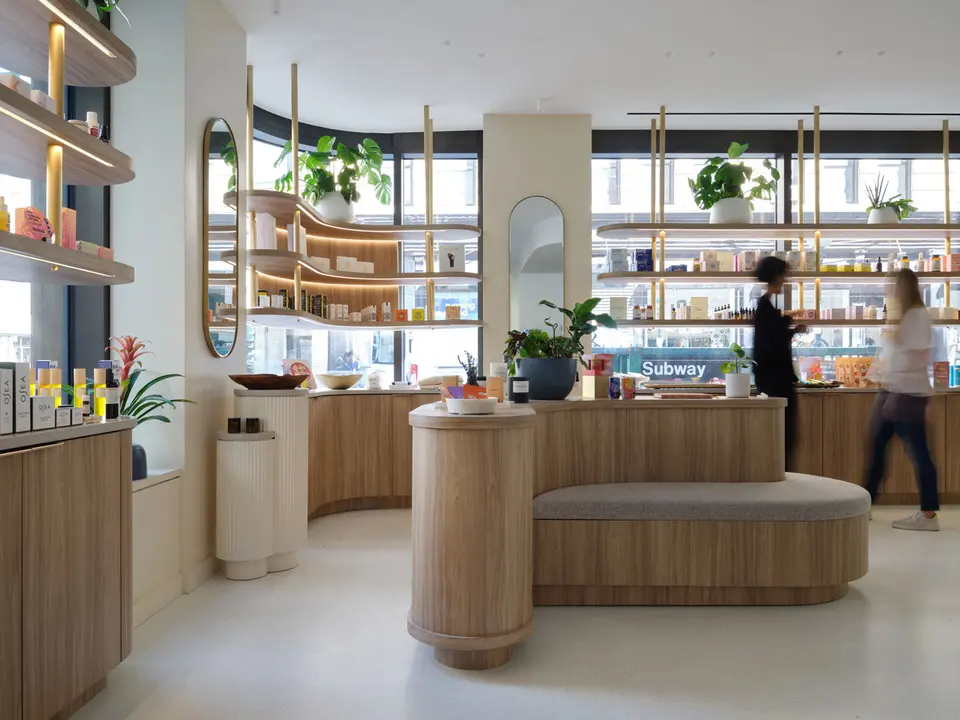 Retail floor with curved wood counters and shelving at Clean Market NoHo