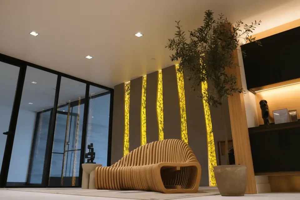 Lobby with sculptural wood bench and lit wall panels at the Human Longevity Bay Area clinic
