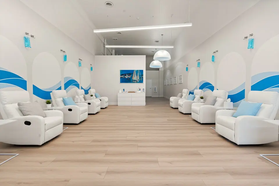Long IV lounge lined with white recliners at Hydration Room Hermosa Beach