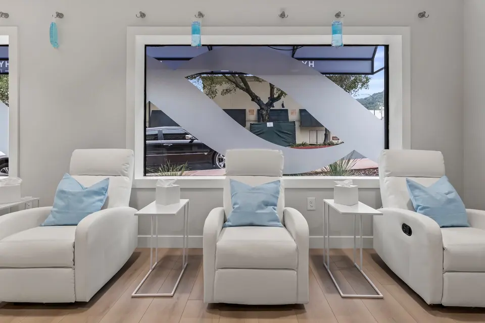 White recliners in front of the street window at Hydration Room Los Gatos