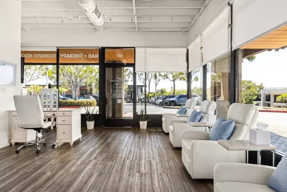 Front desk and IV recliners by the storefront windows at Hydration Room Newport Beach