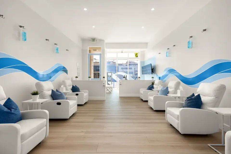 IV lounge with recliners and blue wave murals at Hydration Room Santa Monica