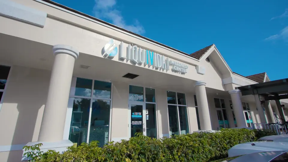 Liquivida storefront with columns and signage at Lauderdale Beach under a blue sky