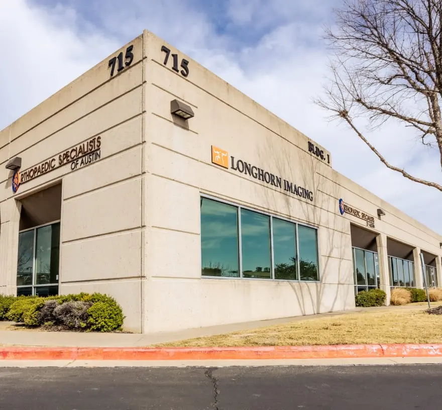 Corner of the beige office building at 715 in Cedar Park with Longhorn Imaging lettering above the windows