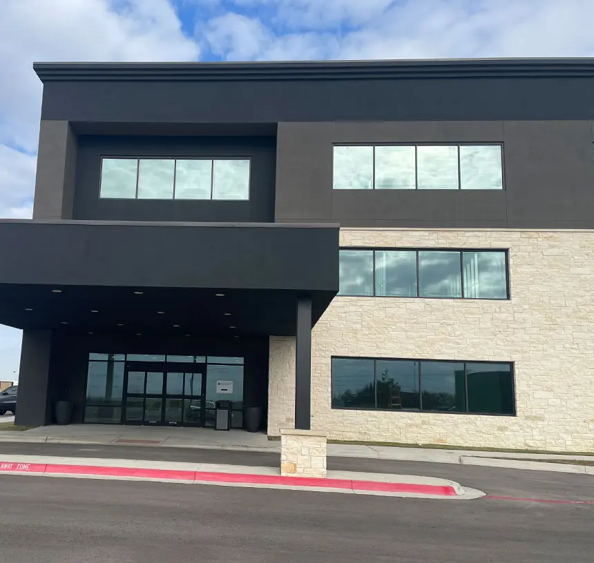 Two-story dark-gray and limestone medical building that houses Longhorn Imaging in Georgetown