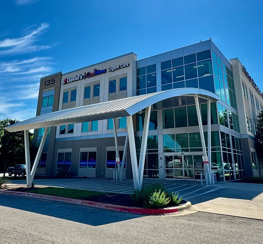Three-story glass medical office building with a curved entrance canopy that houses Longhorn Imaging in Kyle