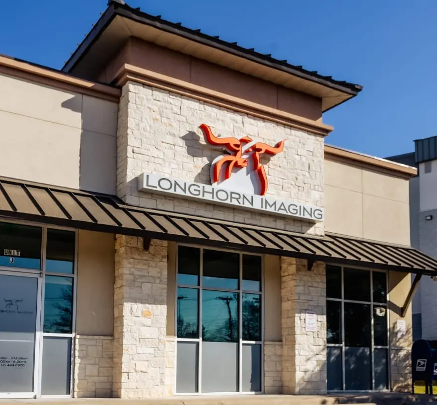 Stone-and-stucco storefront of Longhorn Imaging North Austin with the orange longhorn logo above the entrance