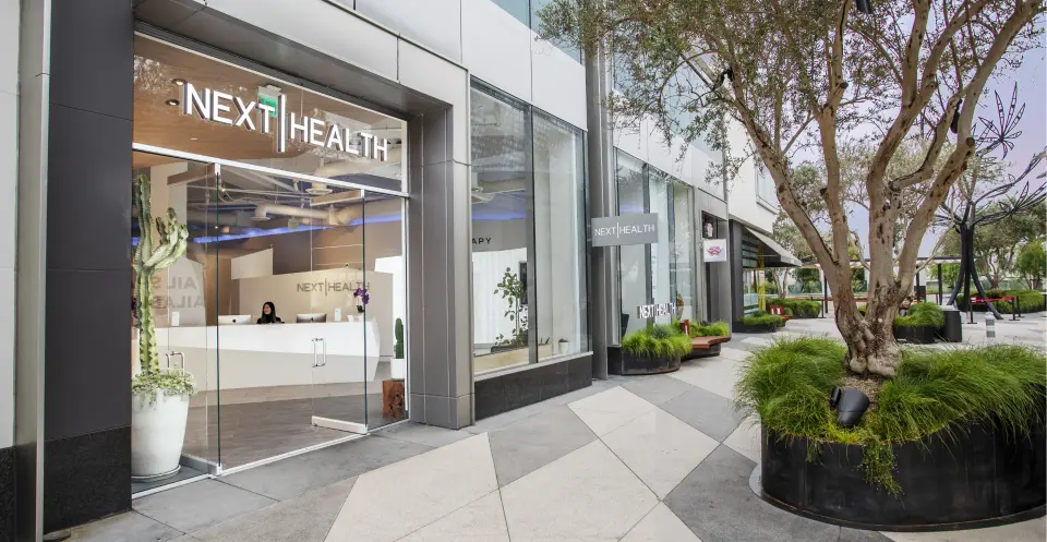 Next Health West Hollywood storefront on a landscaped plaza