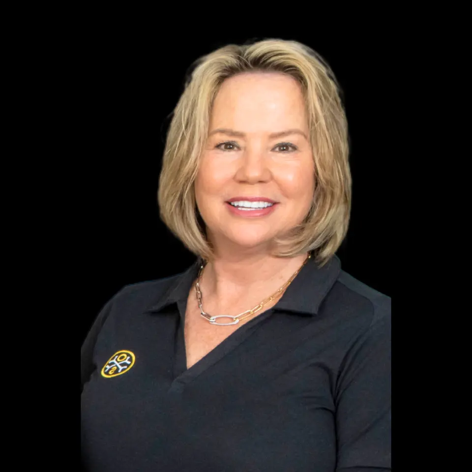Portrait of Cynthia Gaston, co-owner of OsteoStrong Colleyville East, in a branded black polo