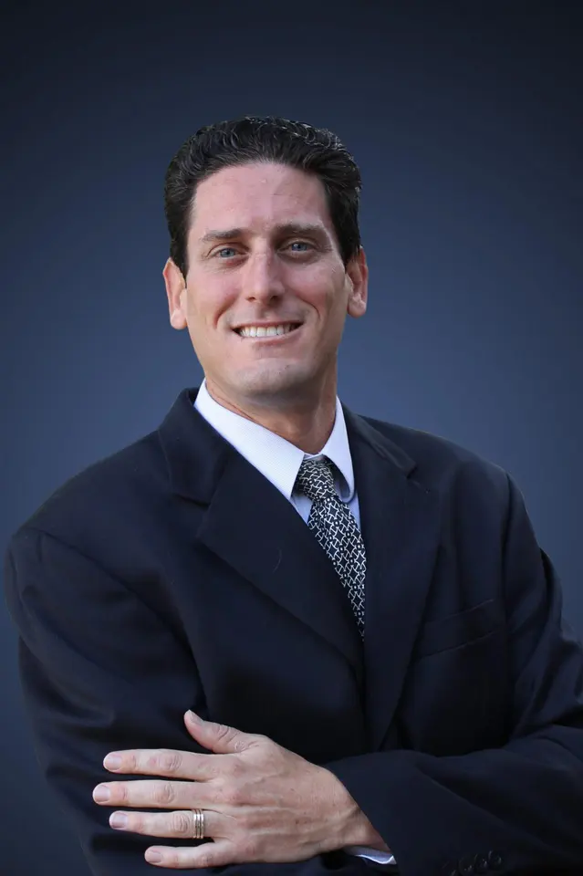 Portrait of Berton Brown of OsteoStrong Juno Beach in a dark suit
