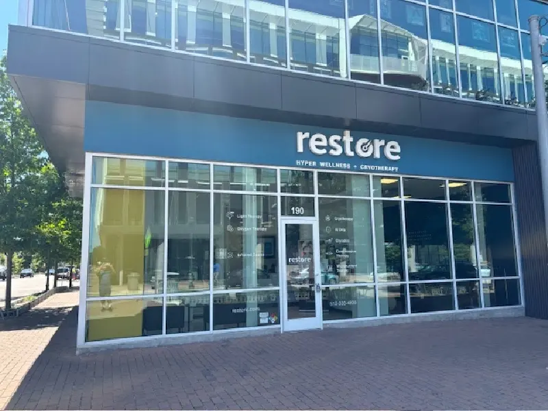 Restore Hyper Wellness storefront at Mueller, suite 190, on the ground floor of a glass building