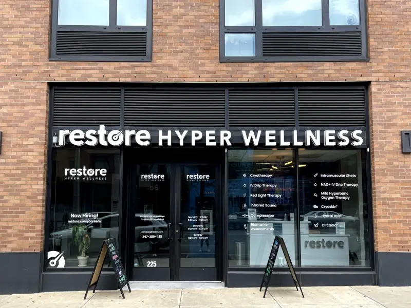 Restore Hyper Wellness storefront with signage on a brick building in Park Slope