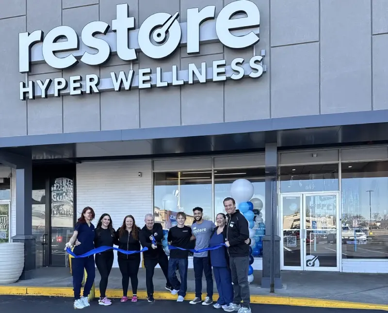 Restore team at a ribbon cutting in front of the Port Chester storefront