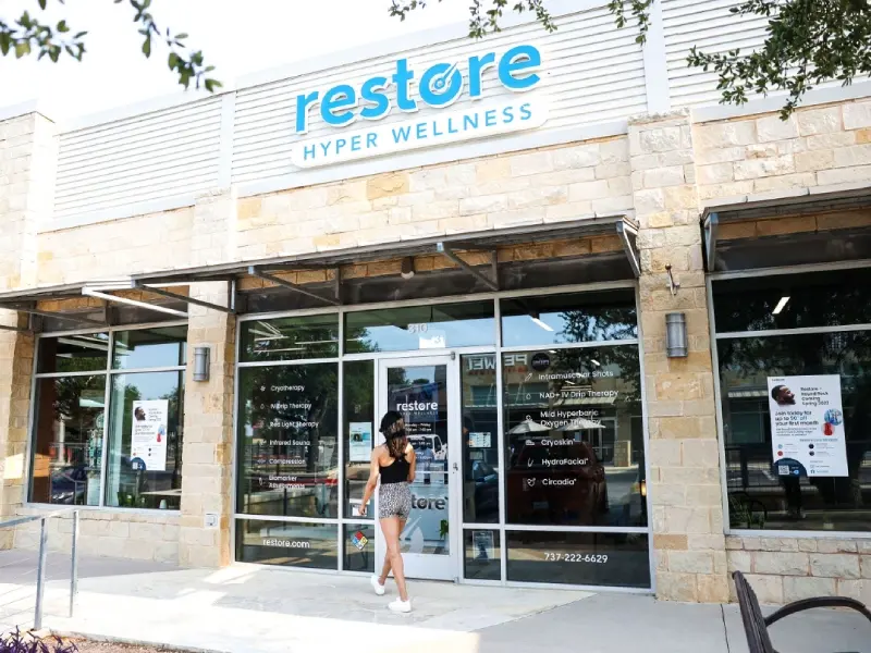 Restore Hyper Wellness storefront with limestone facade and glass entry in Round Rock