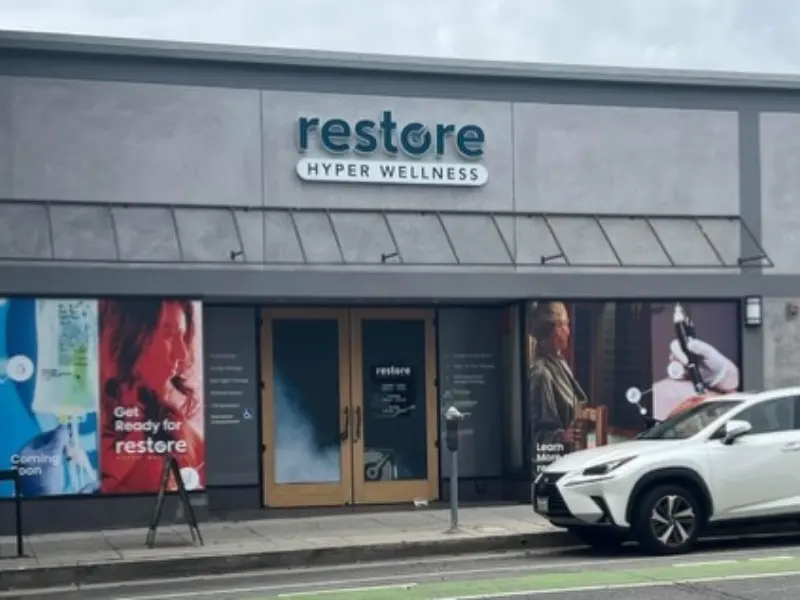 Gray storefront with Restore Hyper Wellness sign in Santa Monica