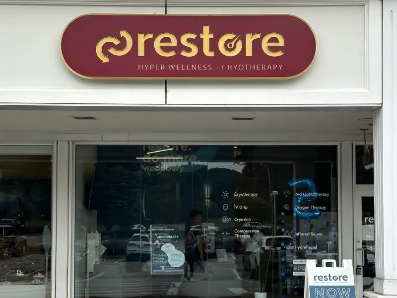 Restore Hyper Wellness and Cryotherapy storefront with red sign in Woodbury