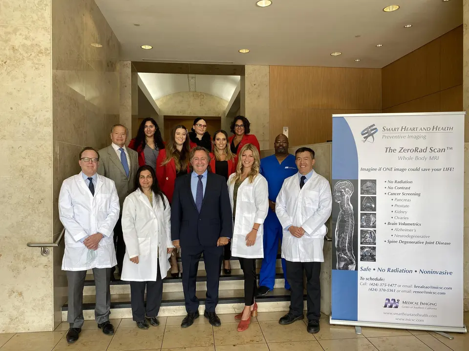 Smart Heart and Health physicians and staff in a building lobby beside a ZeroRad Scan banner