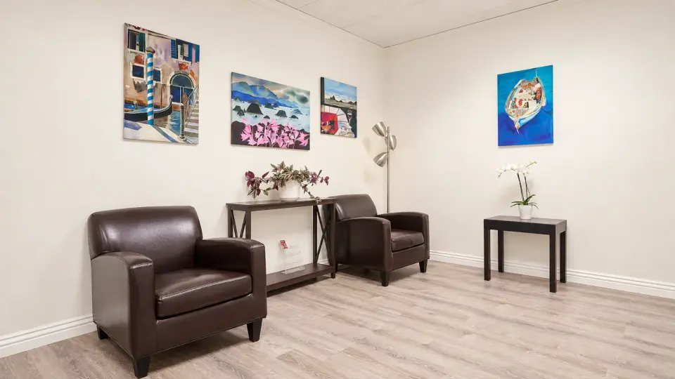 Waiting area with leather armchairs and wall art at SoRay Hyperbarics