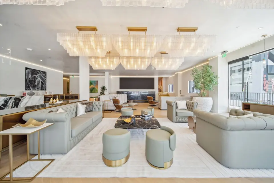 Waiting lounge with sage sofas and chandeliers at Sydenham Clinic Beverly Hills