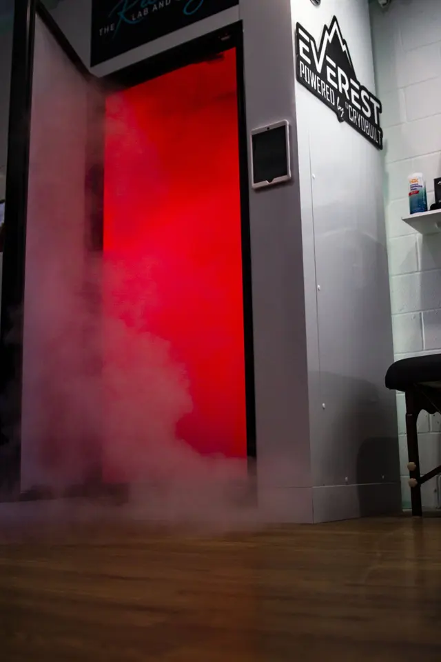 Cryo chamber door with mist rolling out onto the floor beside an Everest sign